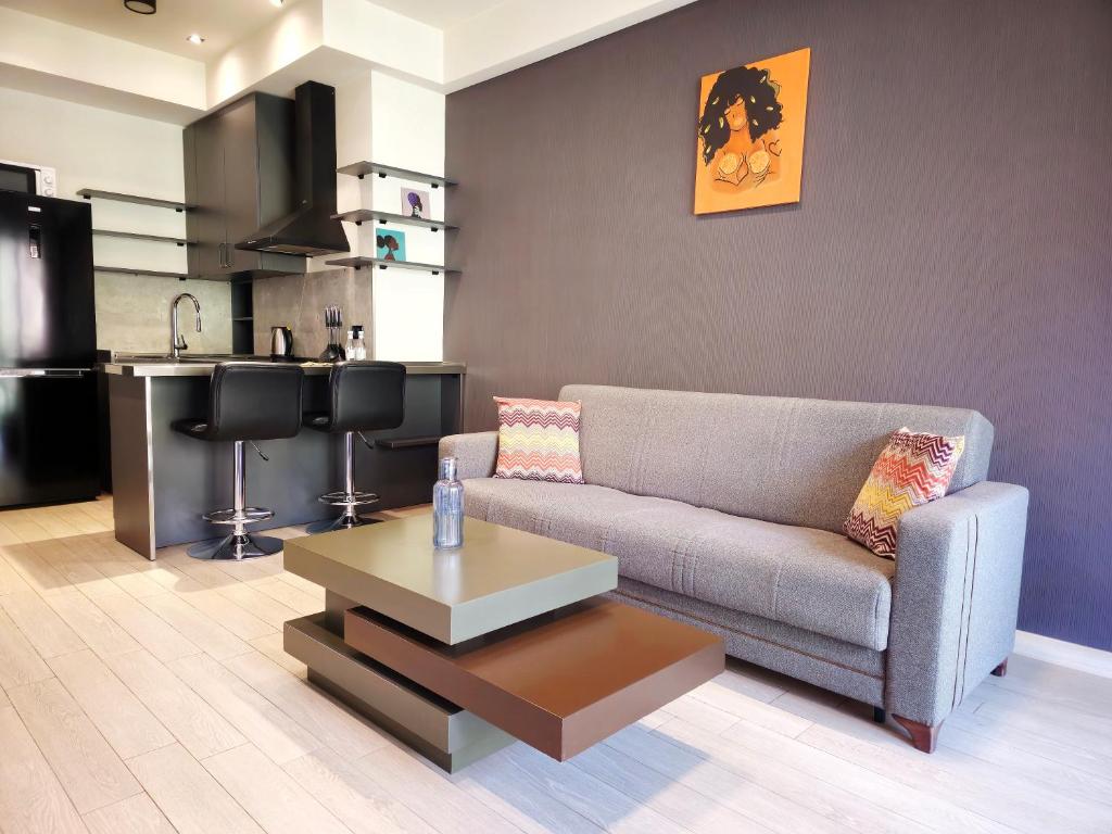 a living room with a couch and a coffee table at Newly Renovated Condo Steps to Republic Square in Yerevan