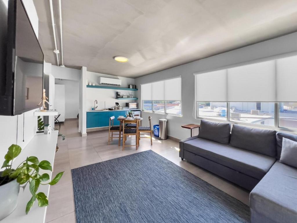 a living room with a couch and a table at Aquabella 7 Paradise Stay in Isla Verde in San Juan