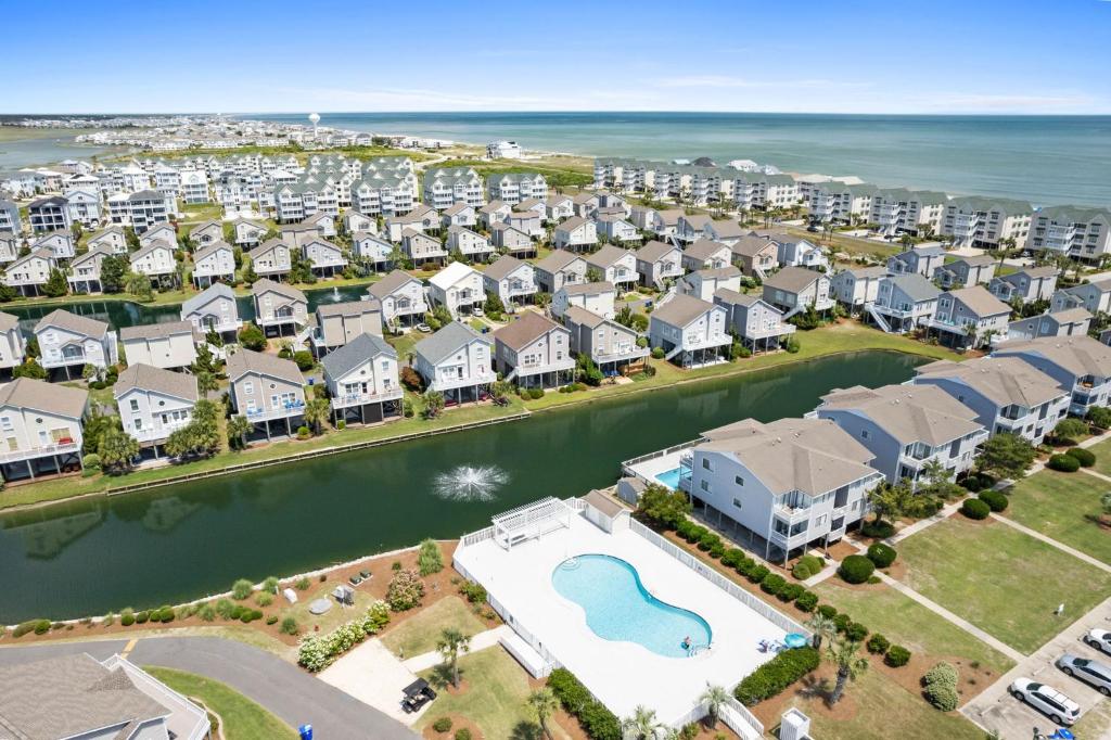 an aerial view of a resort with a pool at 4 BD 3 BA Cottage on Ocean Isle Beach with Water View & Community Pool! in Ocean Isle Beach