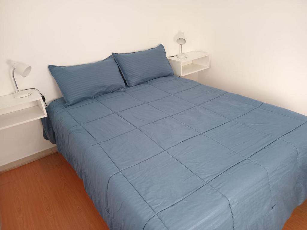 a bedroom with a blue bed with two night stands at Centro de Paraná - 1 Dormitorio !!! in Paraná