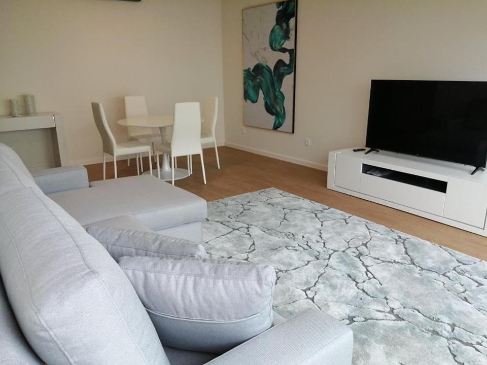 a living room with a couch and a flat screen tv at Azores Paim Apartment T2 in Ponta Delgada