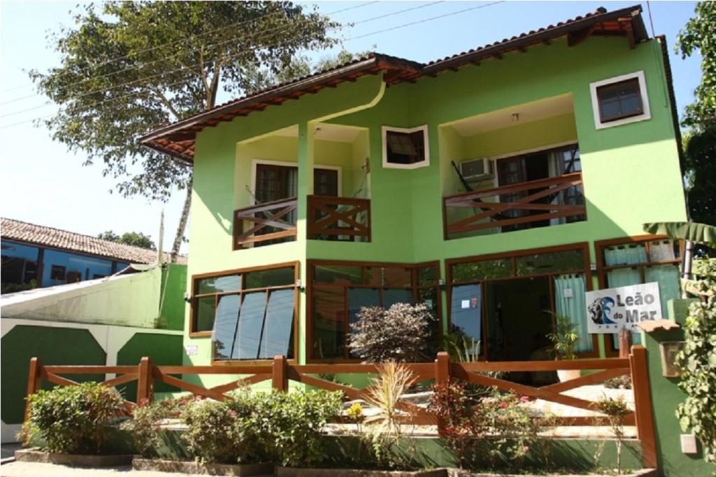 uma casa verde com um sinal em frente em Pousada Leão do Mar em Abraão