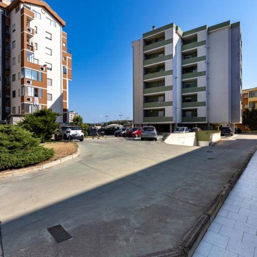 a parking lot with cars parked next to a building at Casa Libeccio in Quartu SantʼElena