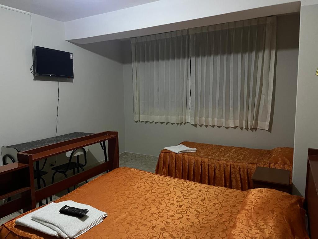 Postel nebo postele na pokoji v ubytování Mi casa Tacna