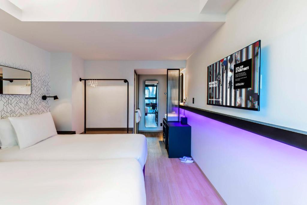 Postel nebo postele na pokoji v ubytování YOTEL Tokyo Ginza