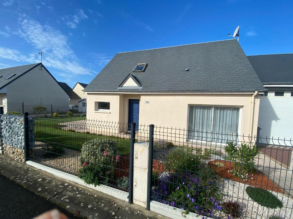 a house with a fence in front of it at Holiday Home in Normandy near Sandy Beach in Hauteville-sur-Mer