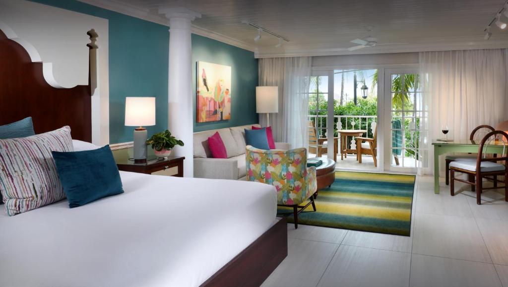 a bedroom with a bed and a living room at Ocean Key Resort & Spa, a Noble House Resort in Key West
