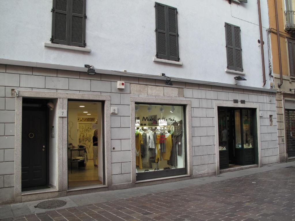 a store front of a building with glass windows at Como Luxury Rooms in Como