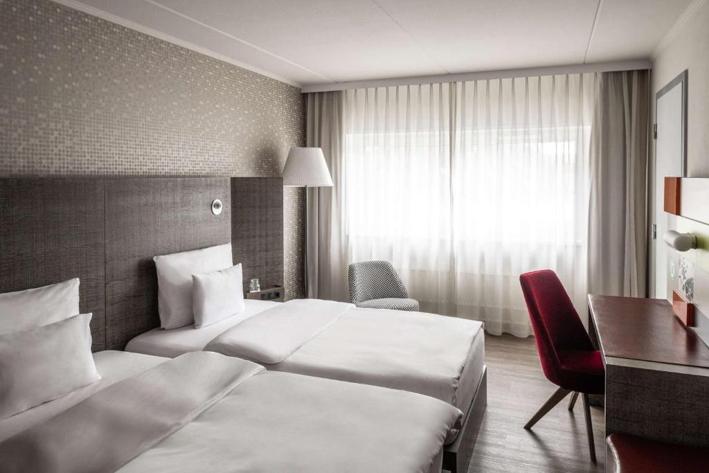 Postel nebo postele na pokoji v ubytování pentahotel Kassel