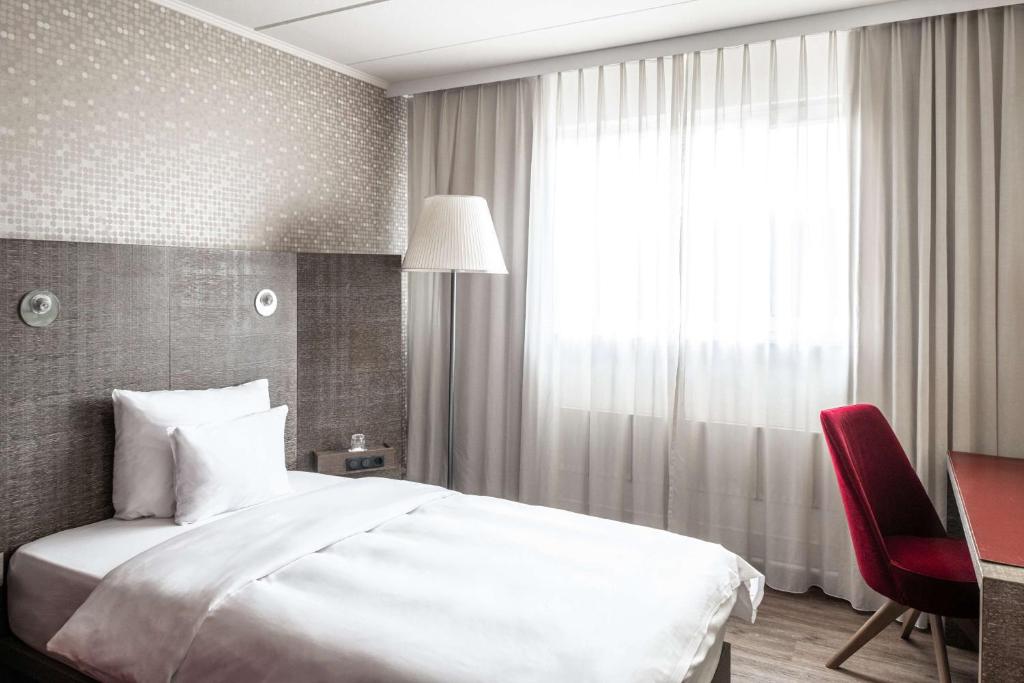 Postel nebo postele na pokoji v ubytování pentahotel Kassel