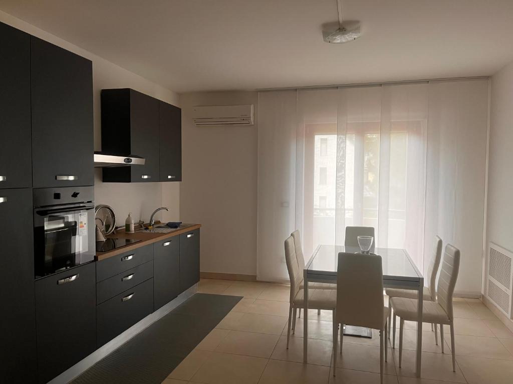 a kitchen with a dining room table and chairs at A un passo in Lanciano