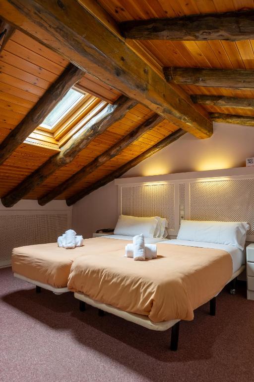 Postel nebo postele na pokoji v ubytování Hotel Micolau