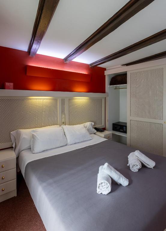 Postel nebo postele na pokoji v ubytování Hotel Micolau
