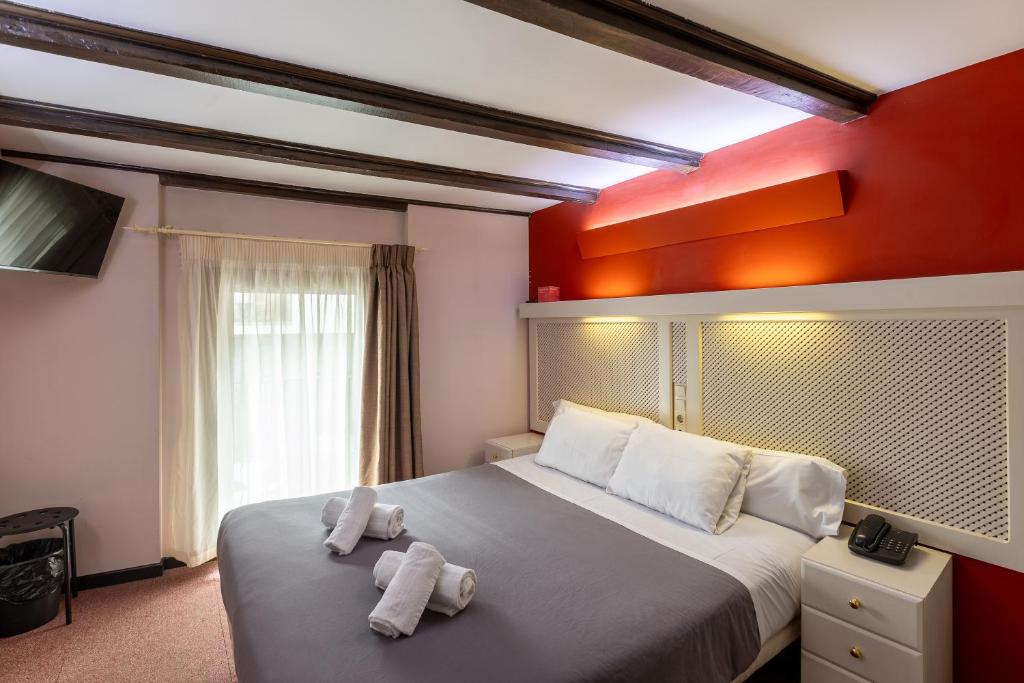 Postel nebo postele na pokoji v ubytování Hotel Micolau