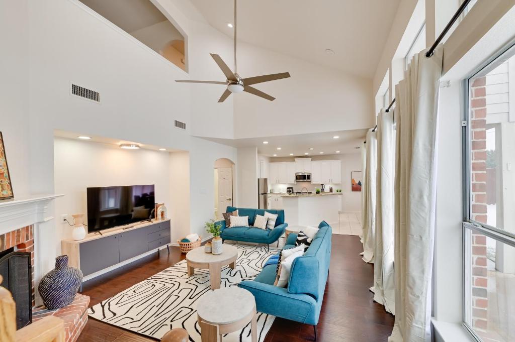 a living room with blue furniture and a fireplace at 4 Mi to Dtwn Family Home with Games in Frisco in Frisco