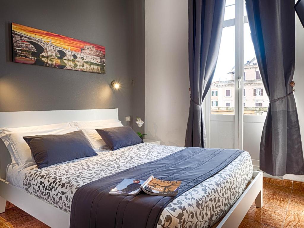 a bedroom with a bed and a large window at Sunny Guest House in Rome