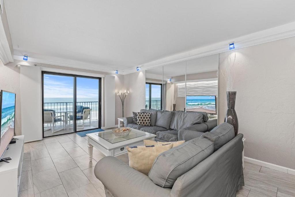 a living room with a couch and a table at 317 - Fantastic 3 BR Oceanfront Corner in Edgewater