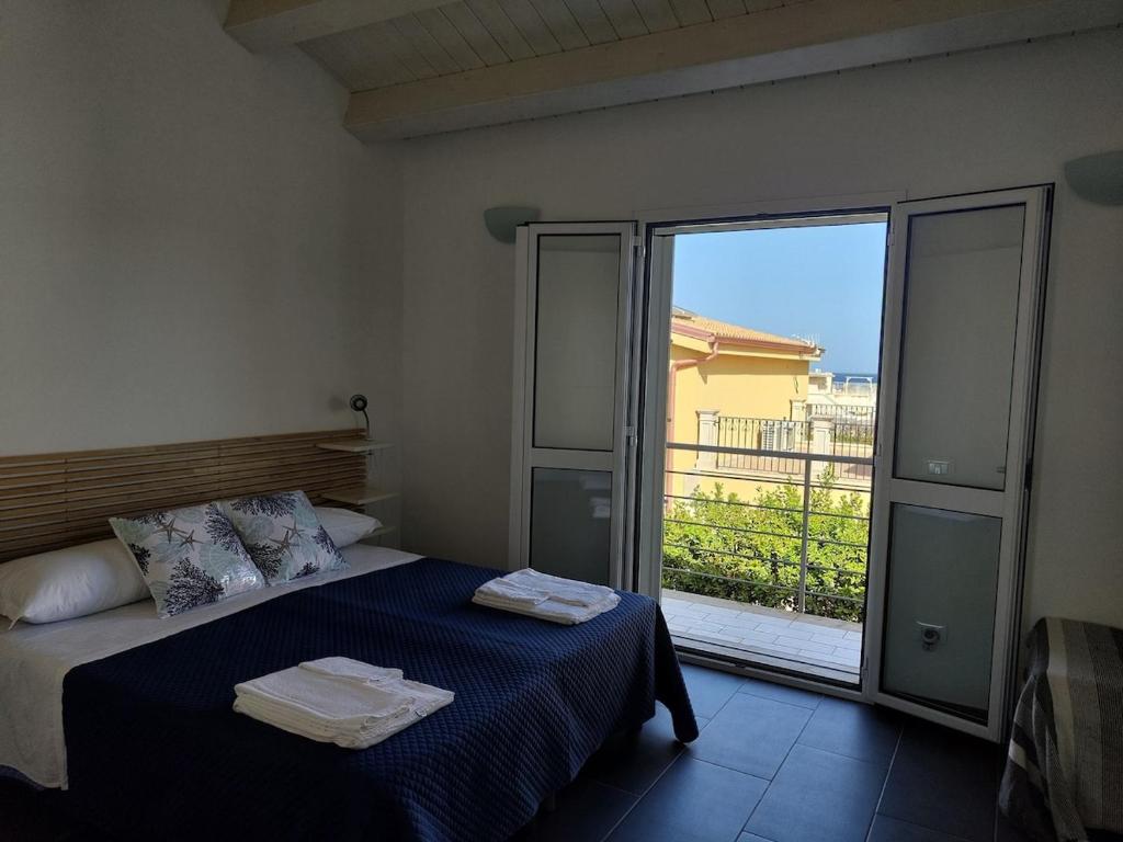 una camera da letto con un letto con due asciugamani sopra di Brezza di Levante a Calabernardo