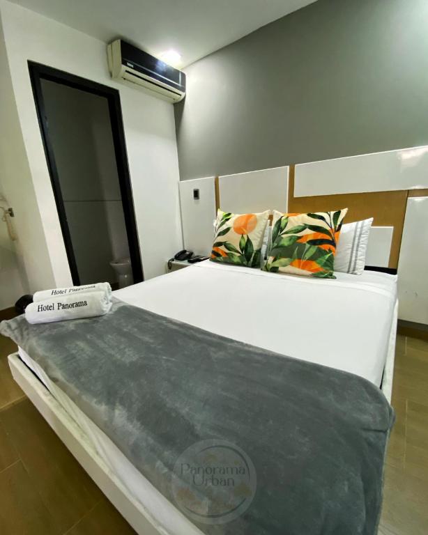 a bedroom with a large bed in a room at Hotel Panorama Urban Medellin in Medellín