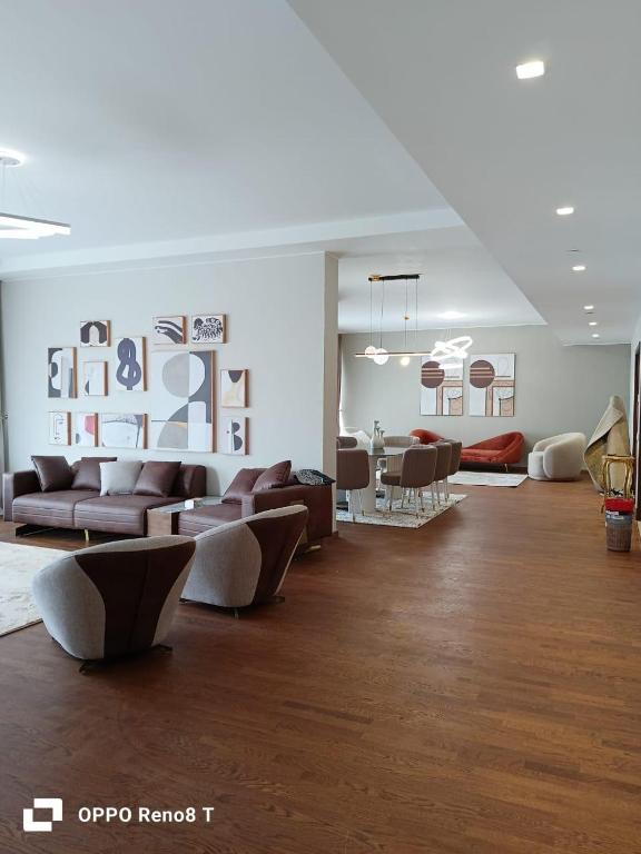 a living room with couches and a dining room at luxury apartment three bedrooms three bathrooms in 6th Of October