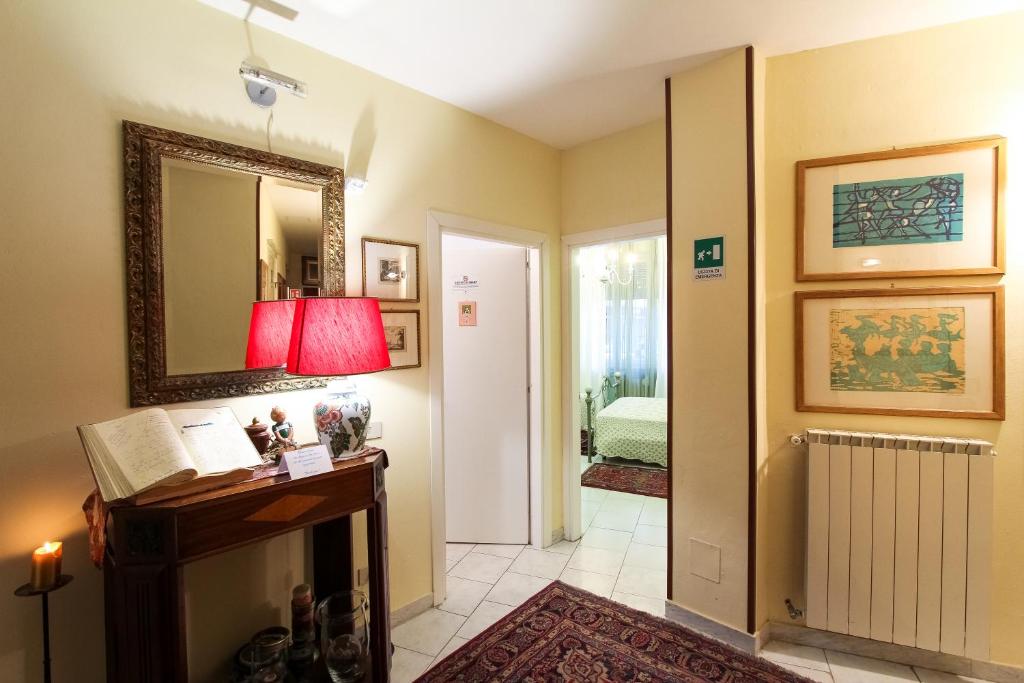 a room with a hallway with a mirror and a table at 6 Keys in Pisa