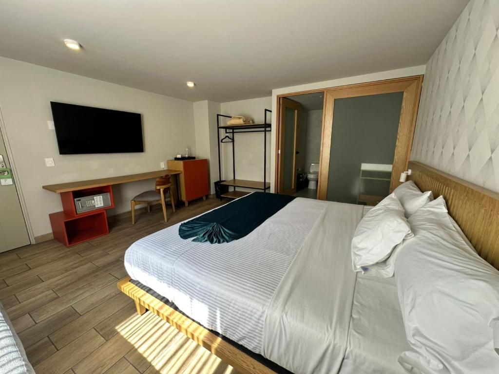 Postel nebo postele na pokoji v ubytování Oliva Plaza Hotel