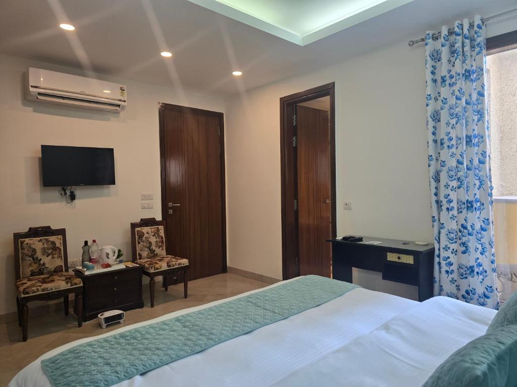 a hotel room with a bed and a television at Two Green Park in New Delhi