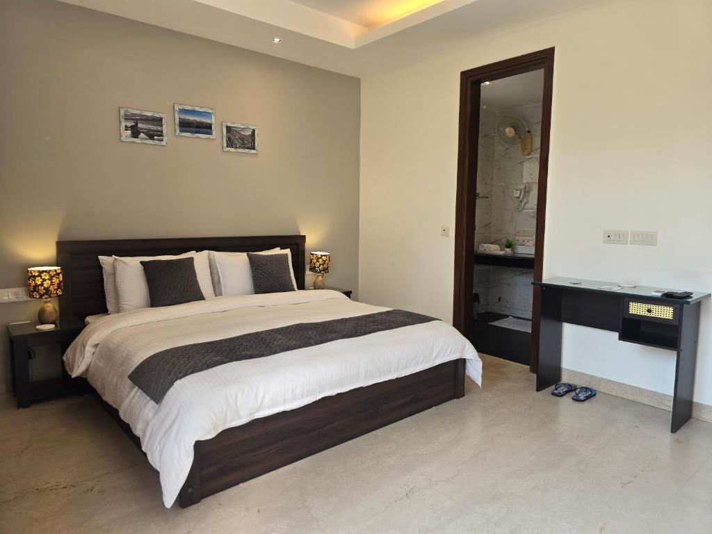 a bedroom with a large bed and a mirror at Two Green Park in New Delhi