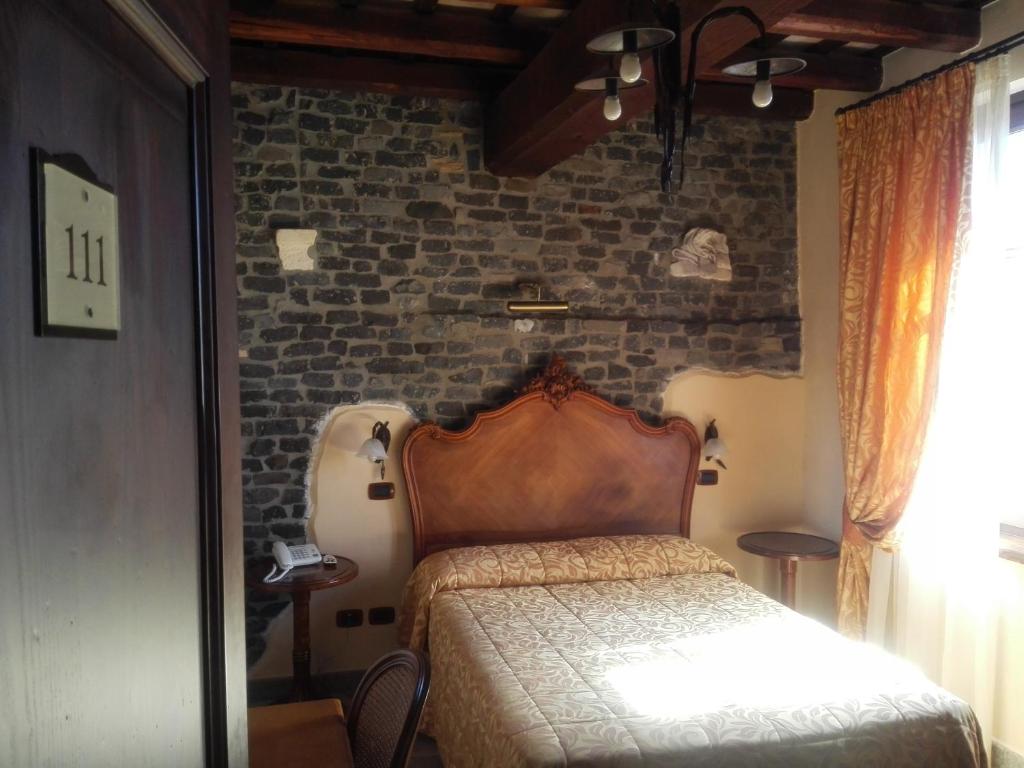 Postel nebo postele na pokoji v ubytování Relais Castrum Boccea