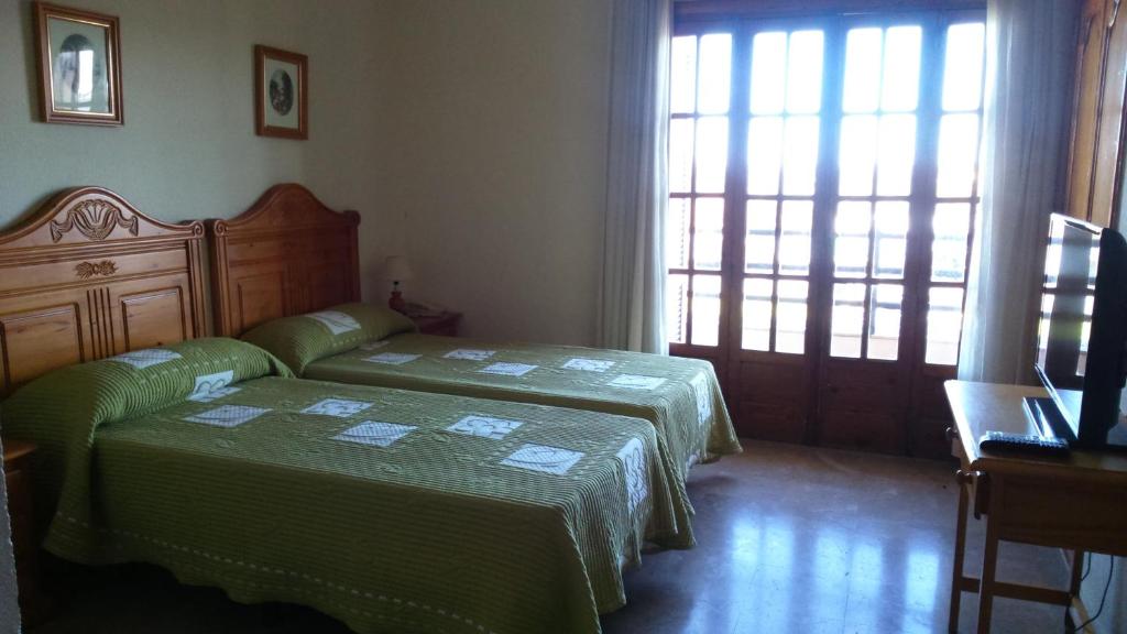 A bed or beds in a room at Hotel Luz de Guadiana