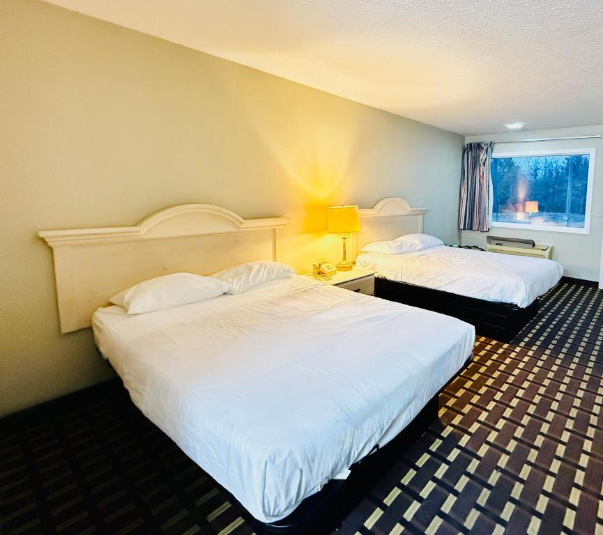 a hotel room with two beds and a window at Travelodge by Wyndham-Thomasville AL in Thomasville