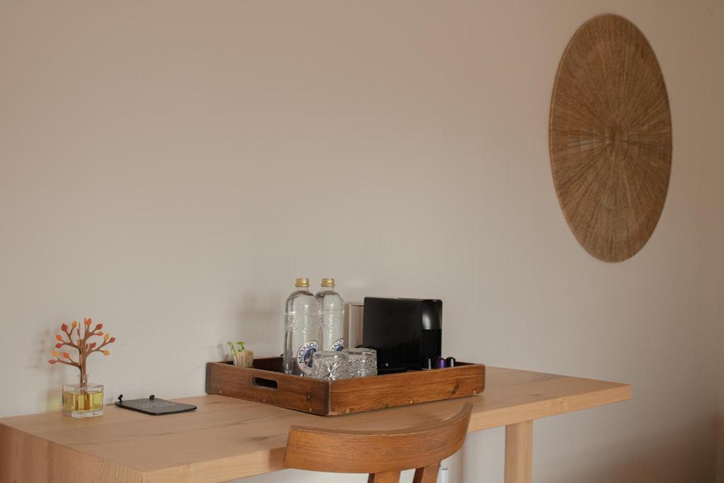 a wooden table with bottles on top of it at Hostal La Torre Ibiza Cap Negret in San Antonio