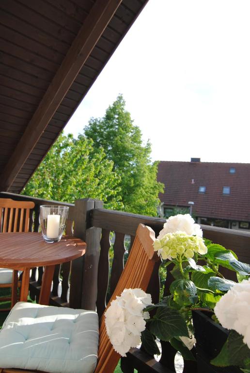 a balcony with a table and a vase of flowers at Ferienwohnung Sonne in Bad Windsheim