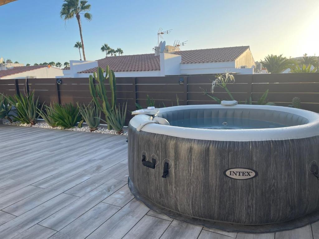 a large wooden bath tub sitting on a deck at Bungalow Maspalomas, Jacuzzi in Maspalomas