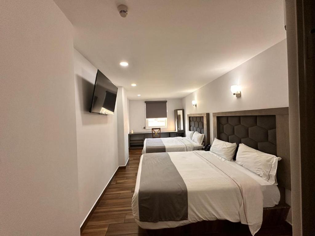 Postel nebo postele na pokoji v ubytování Hotel Bugari Aeropuerto Guadalajara