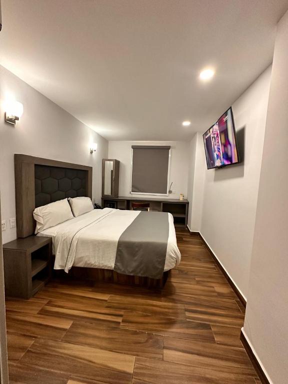 Postel nebo postele na pokoji v ubytování Hotel Bugari Aeropuerto Guadalajara