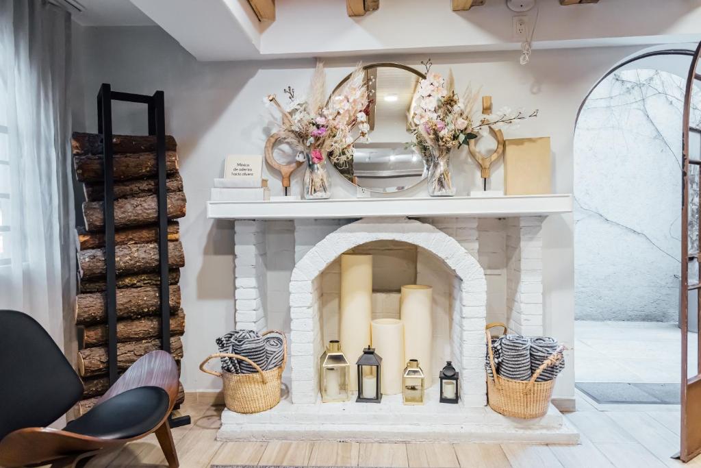 A styled sitting area centered on a white decorative fireplace.