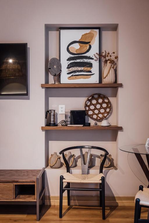A styled work and seating nook with shelves, chair, outlets and nearby media furniture.