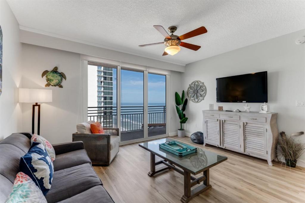 a living room with a couch and a ceiling fan at Unit 2328 Ocean Walk - 2 Bedroom Ocean View in Daytona Beach