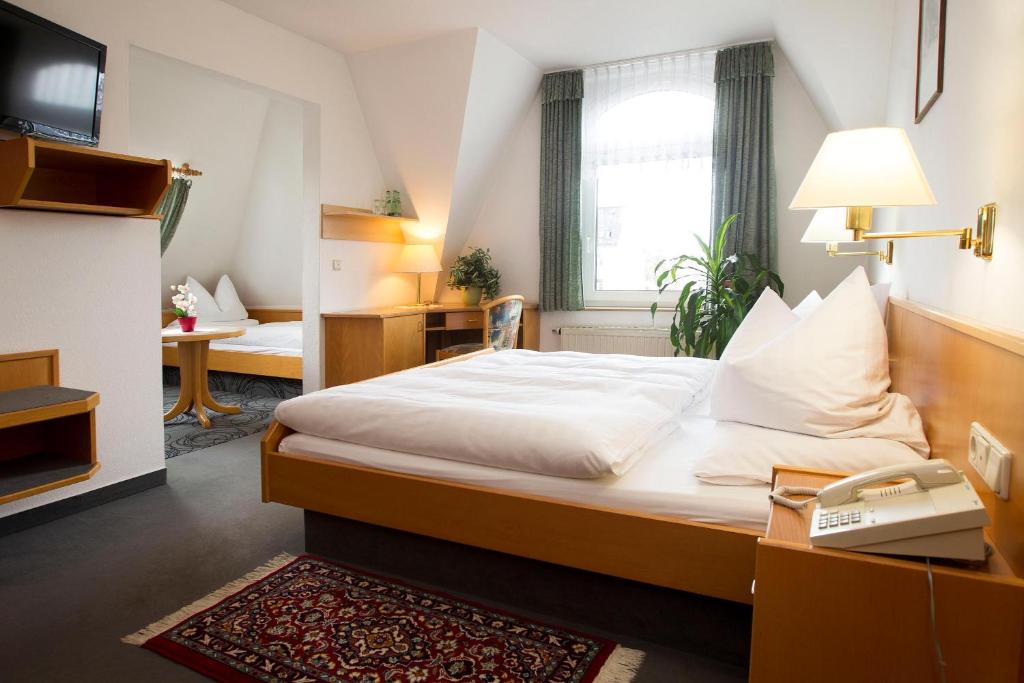 Posteľ alebo postele v izbe v ubytovaní Hotel Heinz
