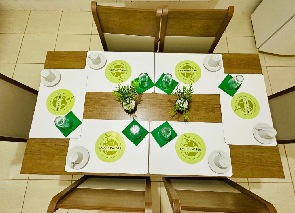 a table with green and white plates and flowers on it at L'Aquolina in Socorro
