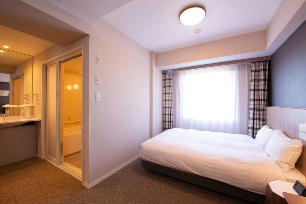 Postel nebo postele na pokoji v ubytování Shinrin Hotel