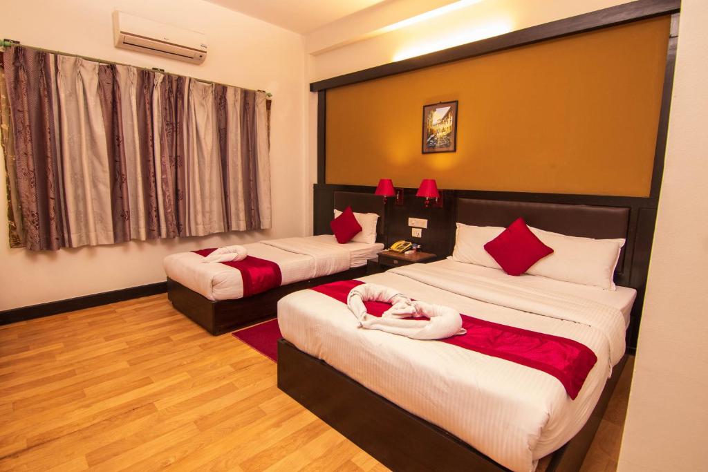 Postel nebo postele na pokoji v ubytování Hotel Ananda Inn