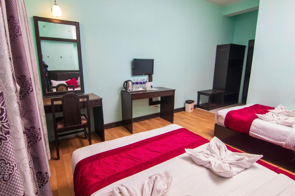 Postel nebo postele na pokoji v ubytování Hotel Ananda Inn