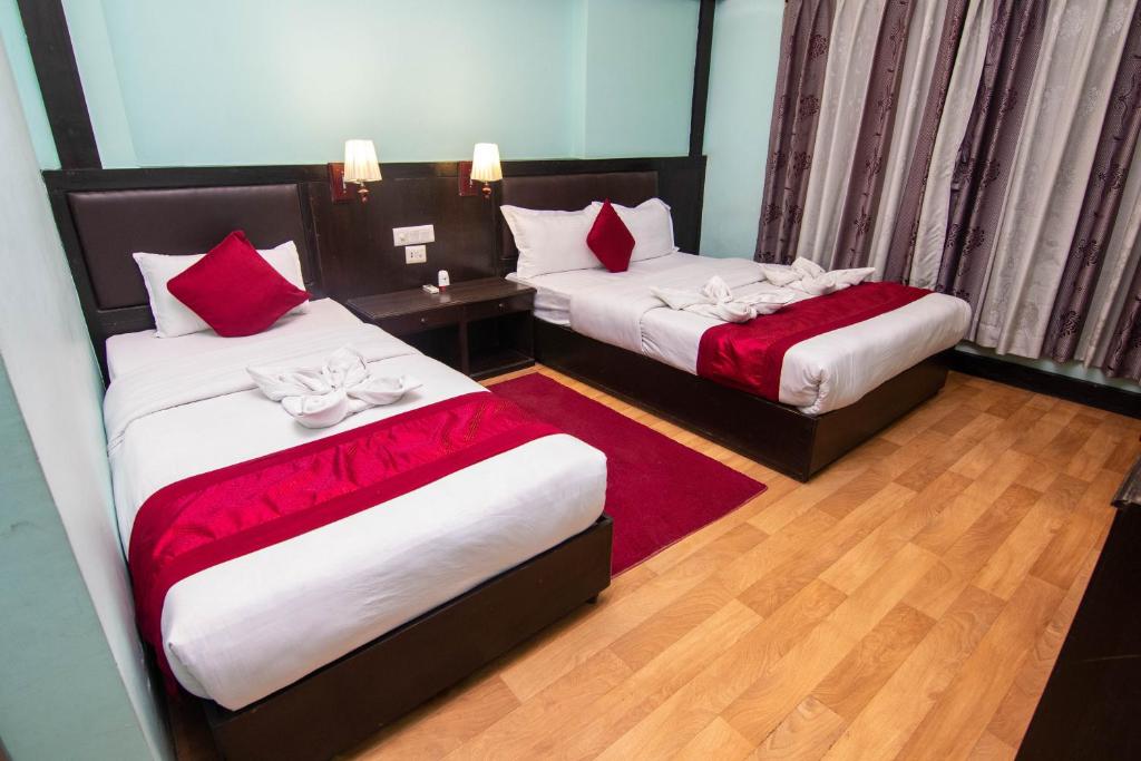Postel nebo postele na pokoji v ubytování Hotel Ananda Inn