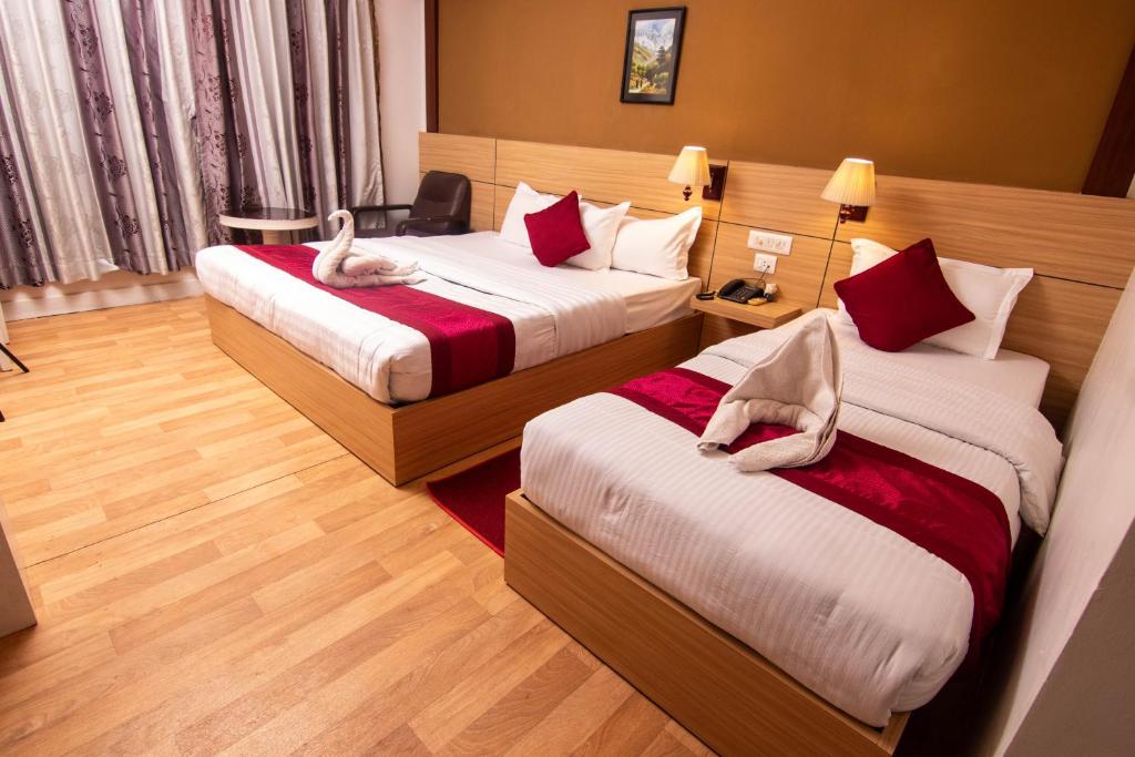 Postel nebo postele na pokoji v ubytování Hotel Ananda Inn
