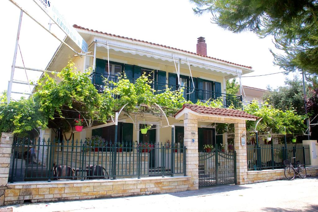 a house with a wrought iron fence in front of it at Asterias in Koronisía