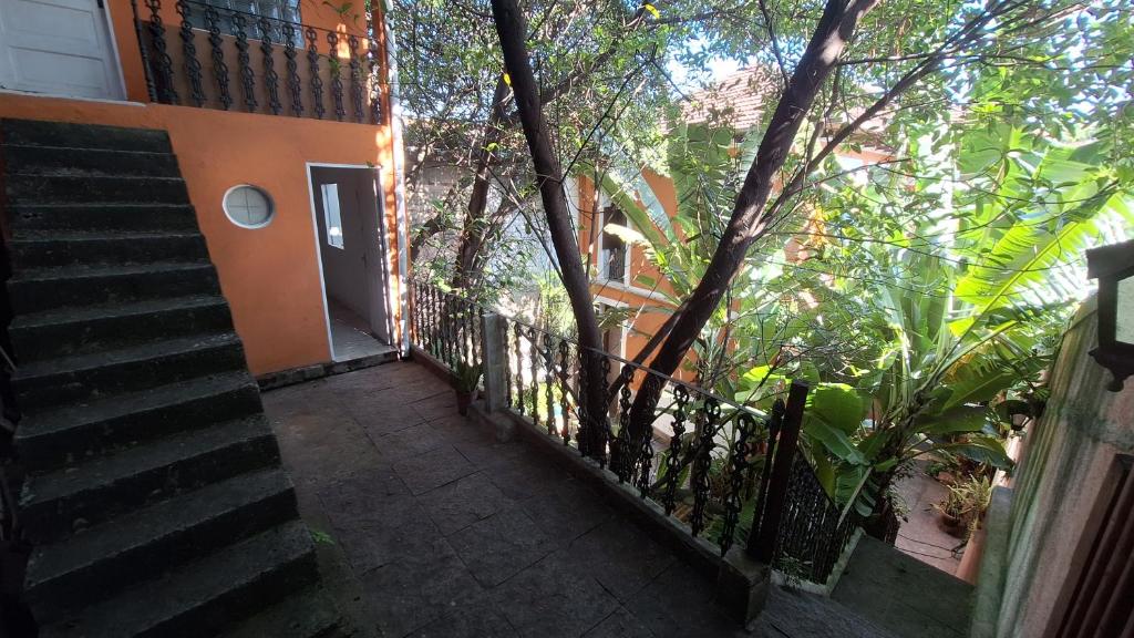 a stairway leading up to a building with a door at Casinha Laranja in Rio de Janeiro