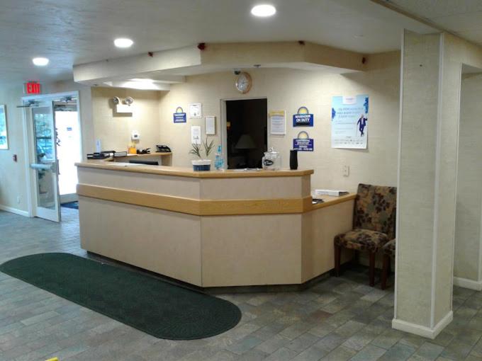 a lobby of a hospital with a reception counter at Sturbridge Plaza Hotel in Sturbridge