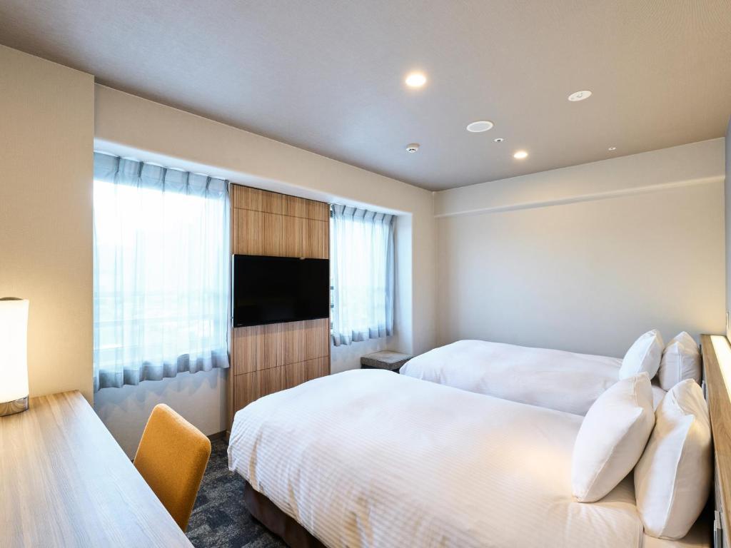 Postel nebo postele na pokoji v ubytování Hotel Elcient Kyoto Hachijoguchi